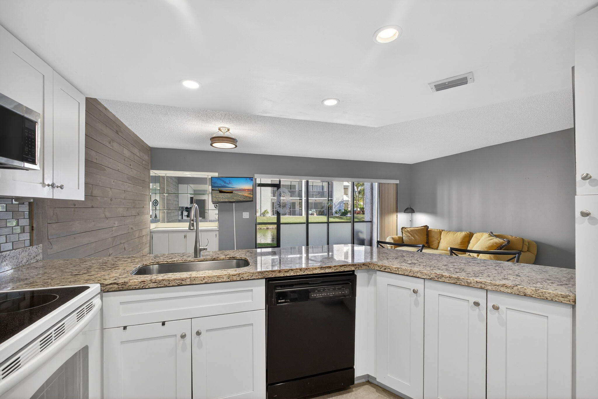 1605 Highway 1, Unit D105 Jupiter, FL 33477 - Photo 8 of 69 a kitchen with granite countertop a sink and a stove