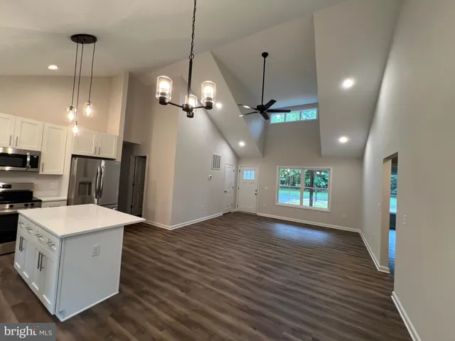 a kitchen with a white cabinets a sink and stainless steel appliances