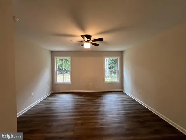 a view of gallery with wooden floor