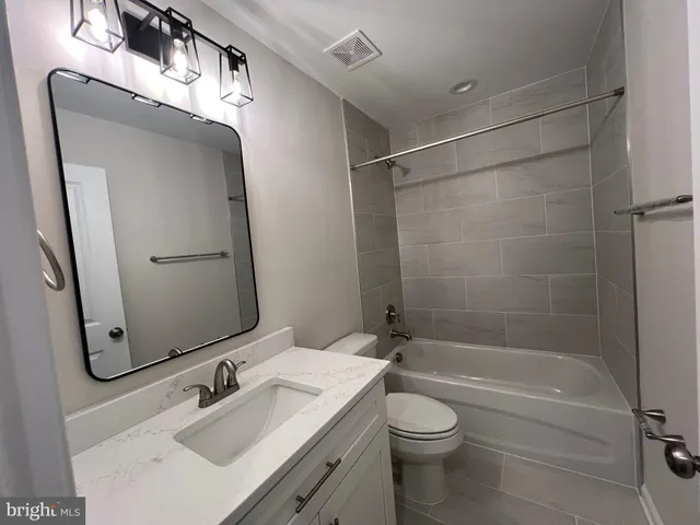 an empty room with wooden floor and closet