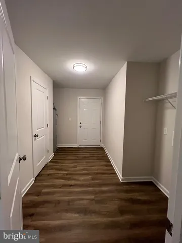 a view of a house with a yard and large tree