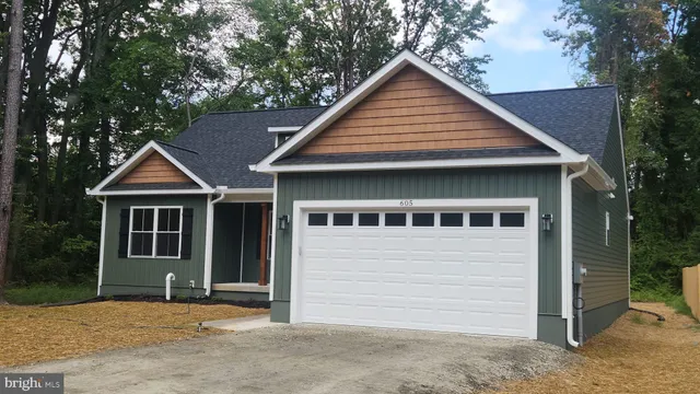 a backyard of a house with yard and trampoline