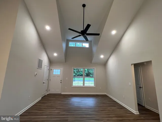 a kitchen with a refrigerator and white cabinets