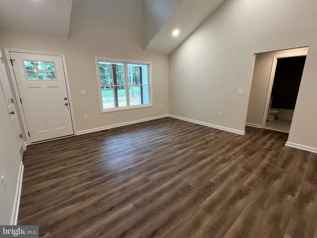 a view of a kitchen with a sink wooden floor and a chandelier