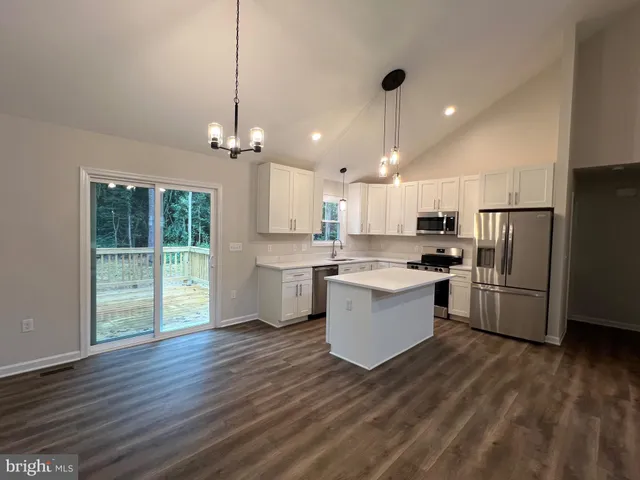 a kitchen with cabinets stainless steel appliances and a sink