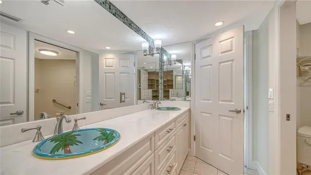 a bathroom with a sink a bathtub a mirror and a shower