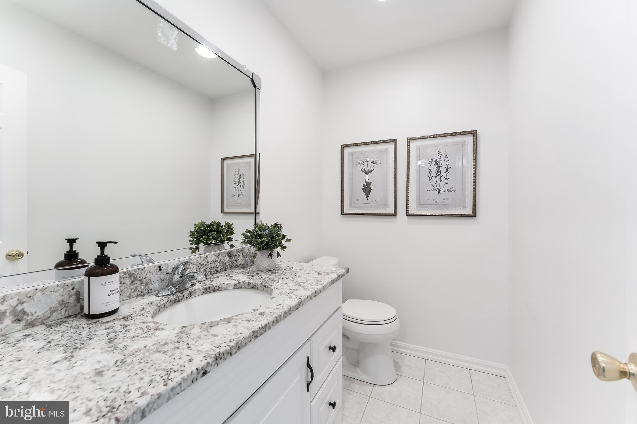 2615 Steeplechase Drive Reston, VA 20191 - Photo 11 of 79 a bathroom with a granite countertop sink and a mirror