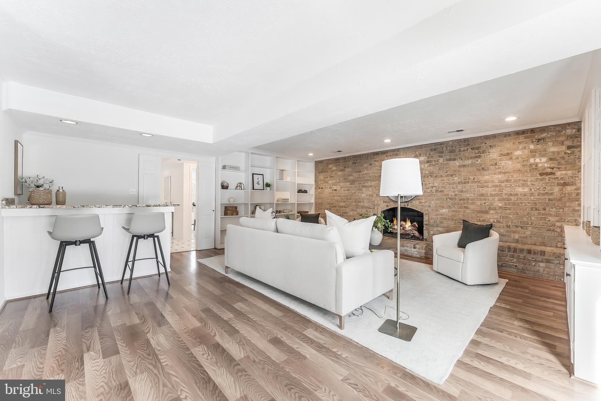 2615 Steeplechase Drive Reston, VA 20191 - Photo 22 of 79 a living room with couches and kitchen view with wooden floor