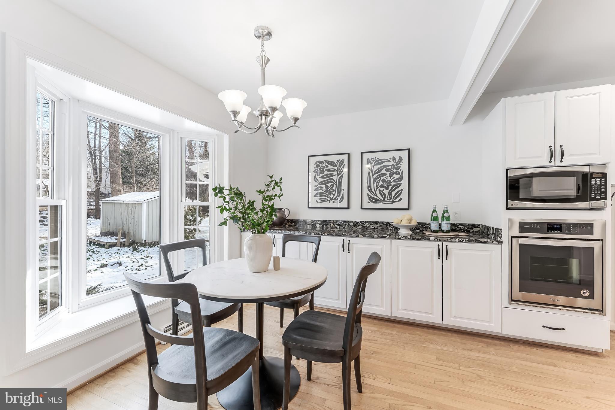 2615 Steeplechase Drive Reston, VA 20191 - Photo 32 of 79 a view of a dining room with furniture a chandelier and wooden floor