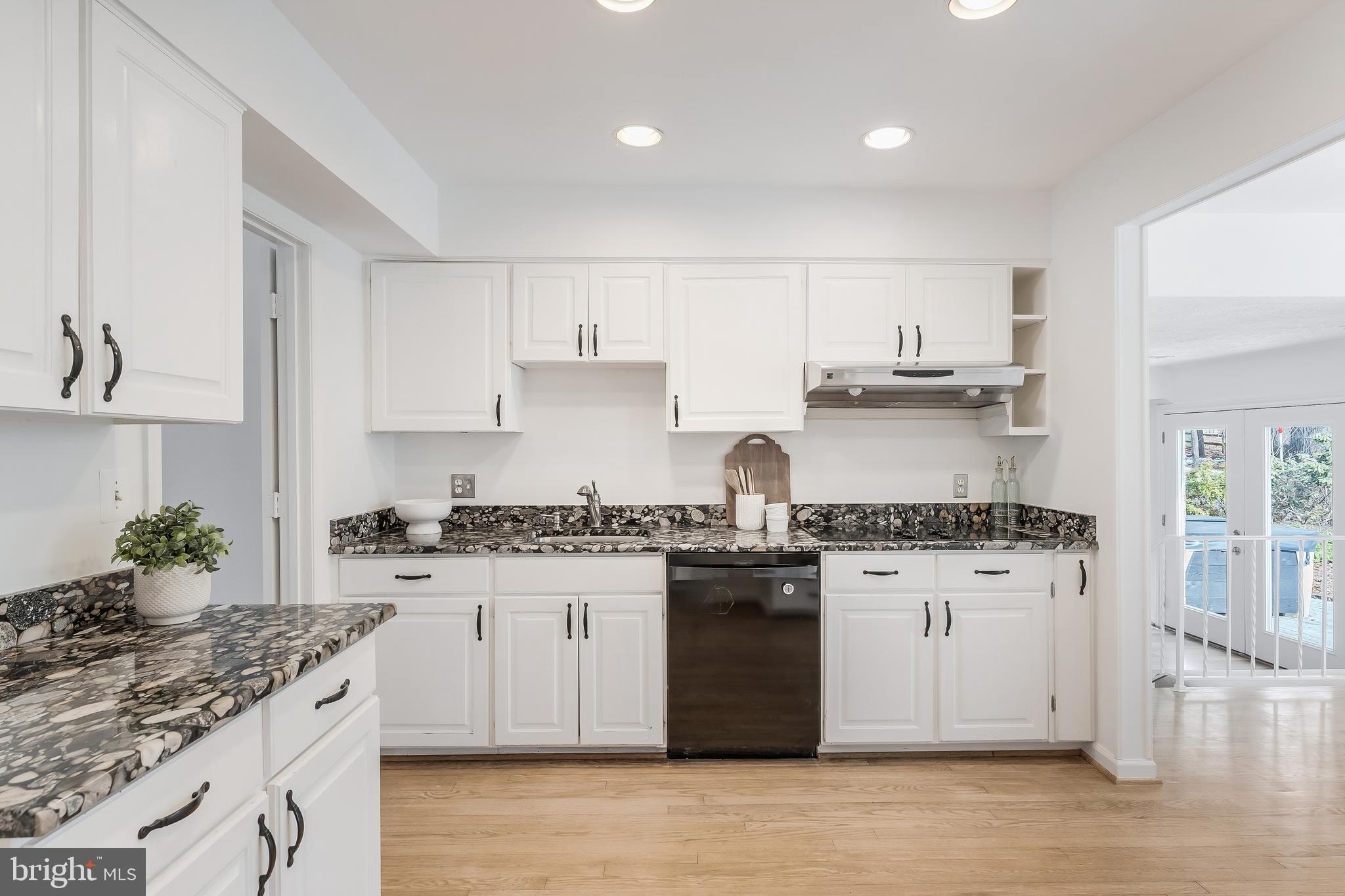 2615 Steeplechase Drive Reston, VA 20191 - Photo 36 of 79 a kitchen with stainless steel appliances granite countertop a stove top oven a sink a refrigerator and white cabinets
