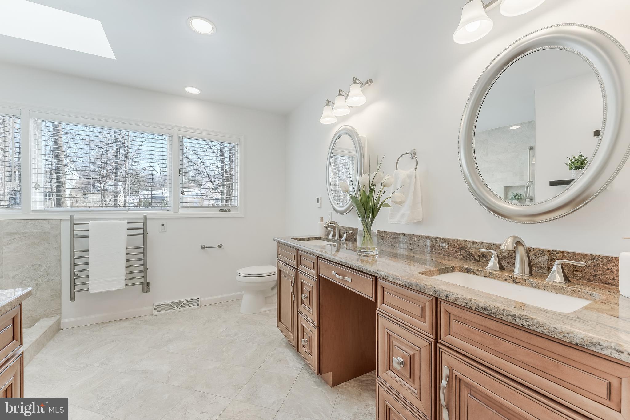 2615 Steeplechase Drive Reston, VA 20191 - Photo 50 of 79 a bathroom with a granite countertop toilet a sink and a mirror