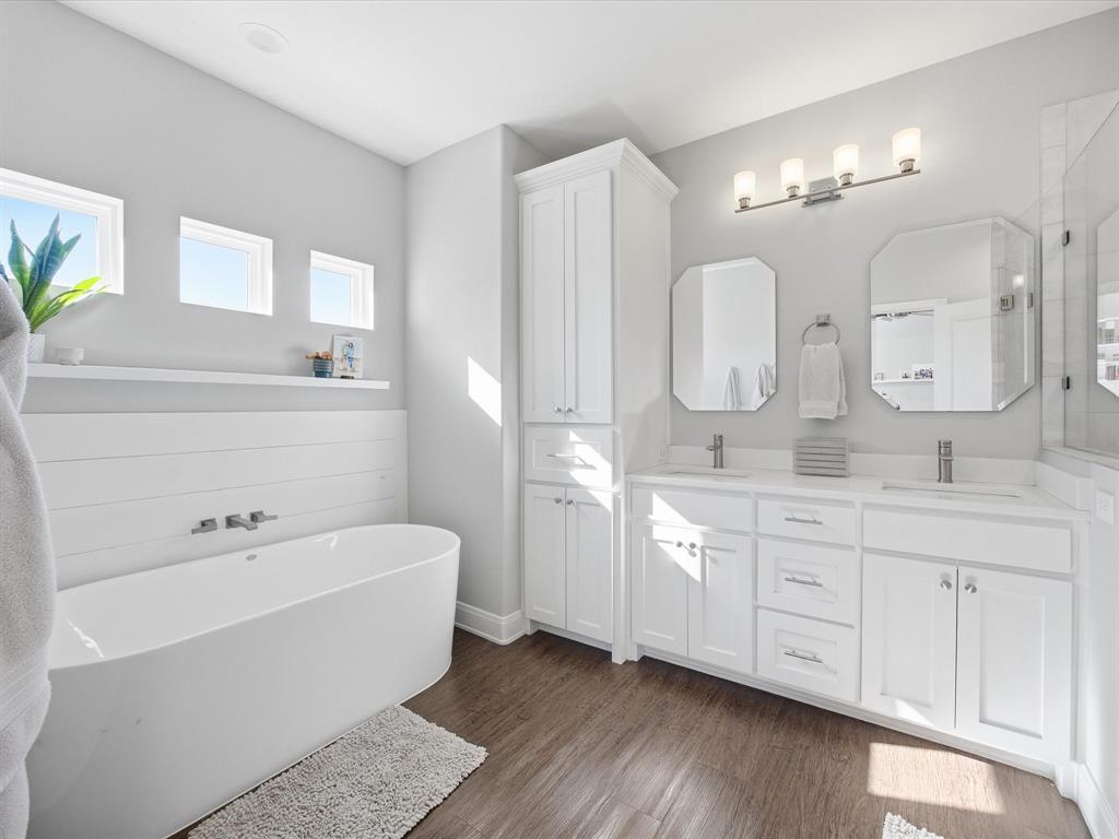608 Timberline Drive Bridgeport, TX 76426 - Photo 17 of 33 Spa-inspired bath with freestanding tub, double vanity, abundant cabinetry, and sunlit windows.