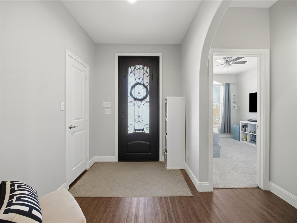 608 Timberline Drive Bridgeport, TX 76426 - Photo 4 of 33 Welcoming entry with arched doorway, rich wood-look floors, and an elegant glass front door.