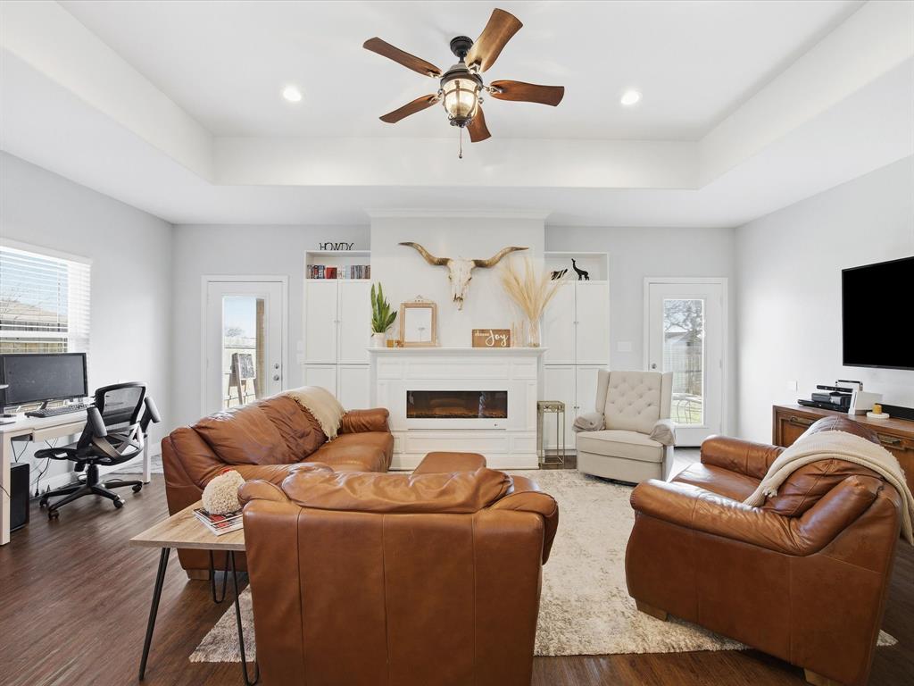 608 Timberline Drive Bridgeport, TX 76426 - Photo 5 of 33 Sunlit living room with vaulted ceiling, built-in cabinetry, and a sleek electric fireplace focal wall.