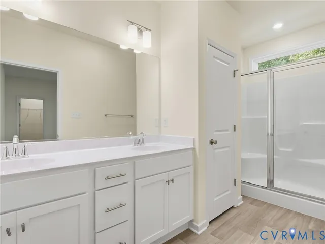 a bathroom with a double vanity sink and mirror