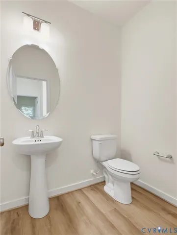 a bathroom with a sink toilet and a mirror