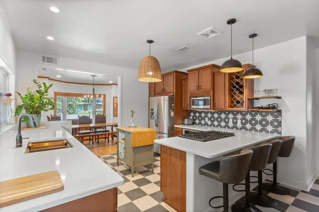 a kitchen that has a table and chairs in it