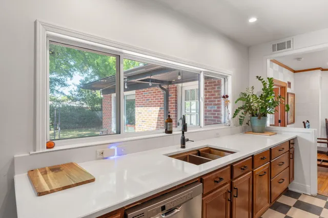 a kitchen with a sink and large window