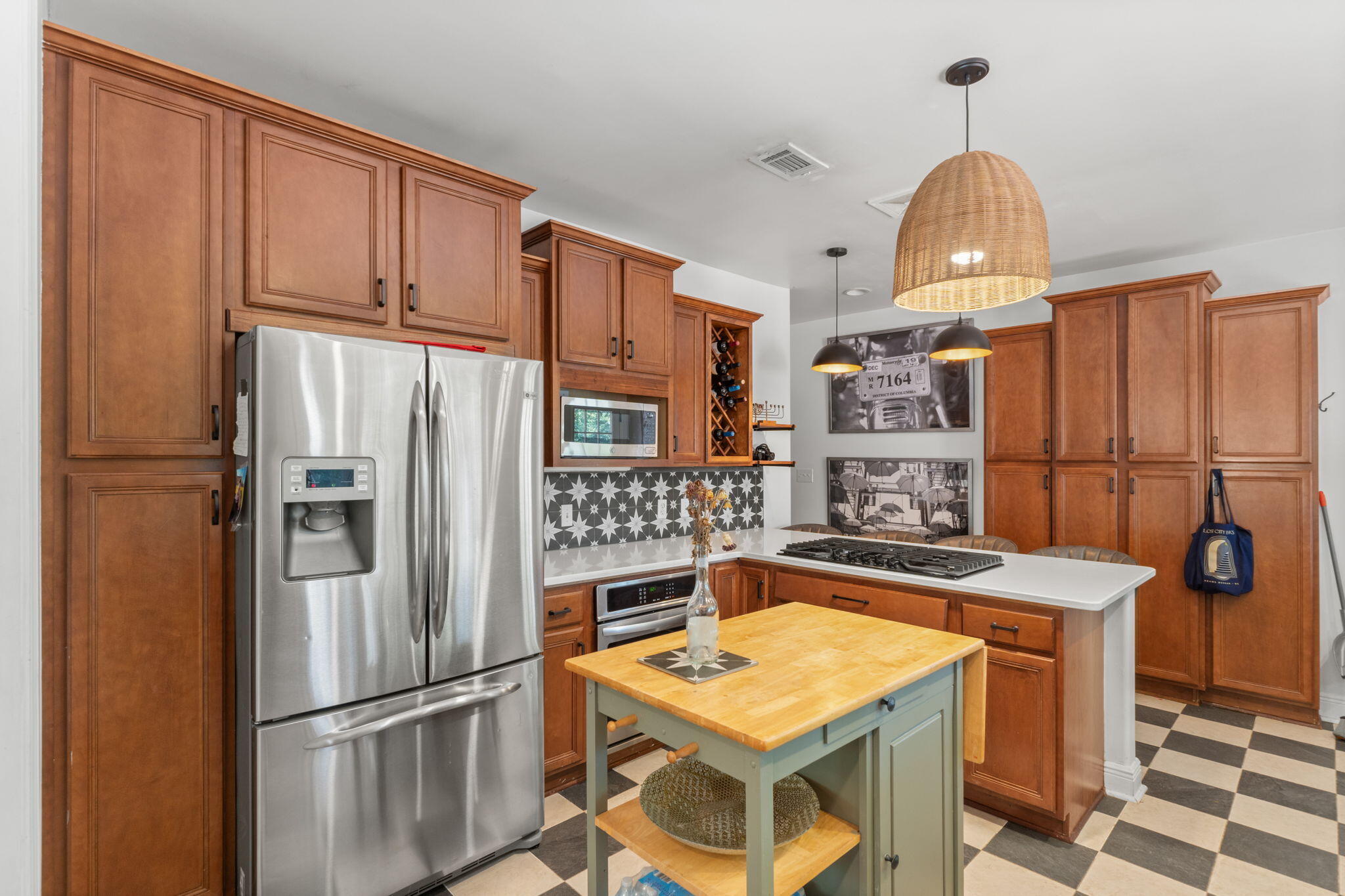 2016 East Scott Street Pensacola, FL 32503 - Photo 15 of 26 a kitchen with stainless steel appliances granite countertop a refrigerator a stove and a sink with cabinets