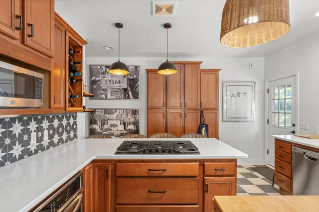 a kitchen with a stove and a chandelier