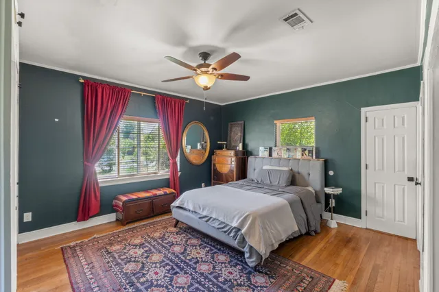 a bedroom with a bed dresser and a window
