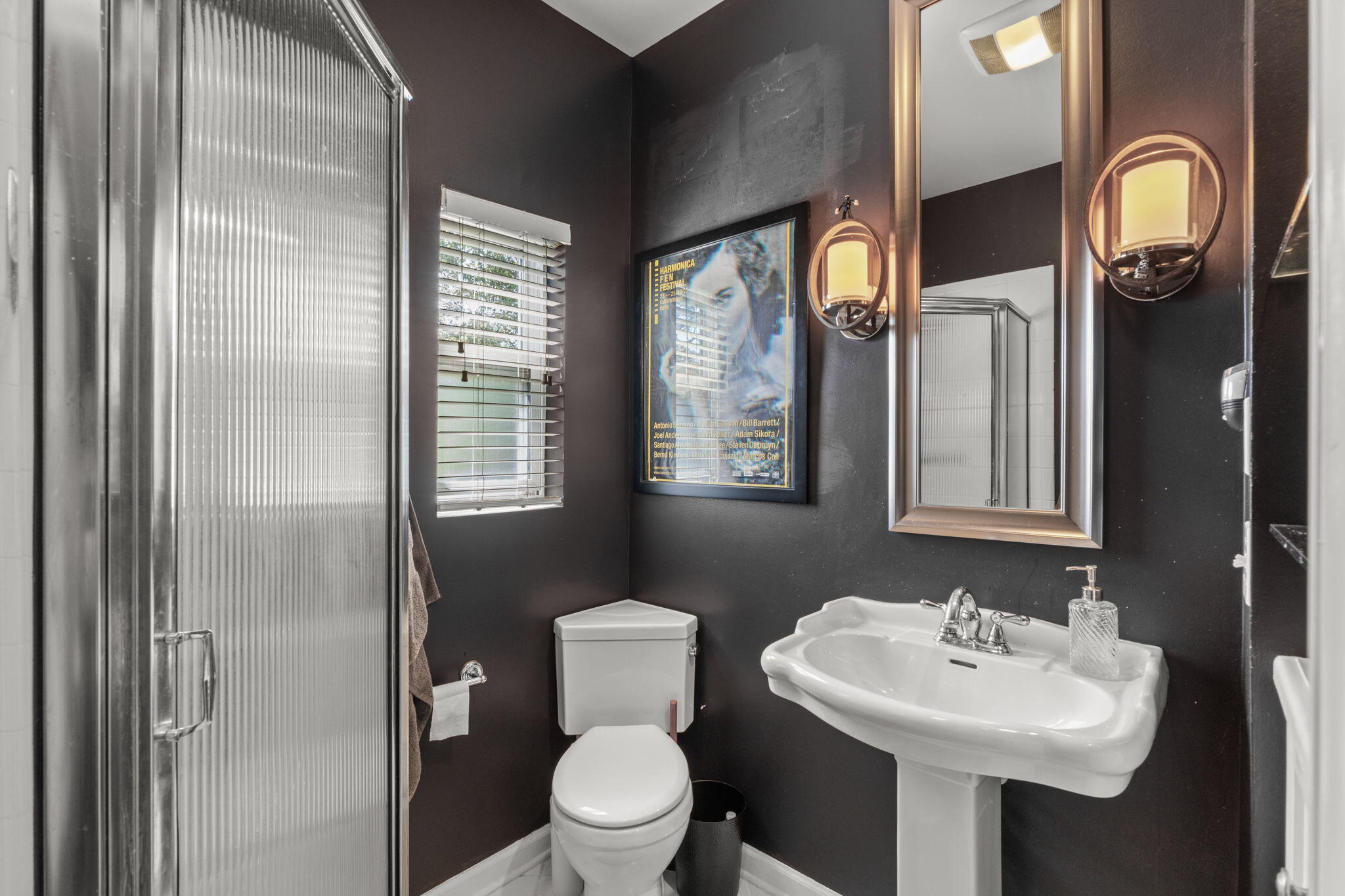 2016 East Scott Street Pensacola, FL 32503 - Photo 22 of 26 a bathroom with a toilet sink and mirror