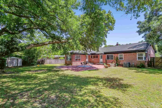 a house view with a sitting space and garden