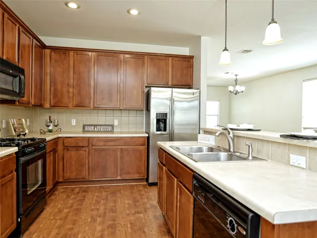 a kitchen with a sink stove and cabinets