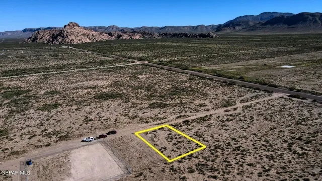 a view of a field with an ocean view
