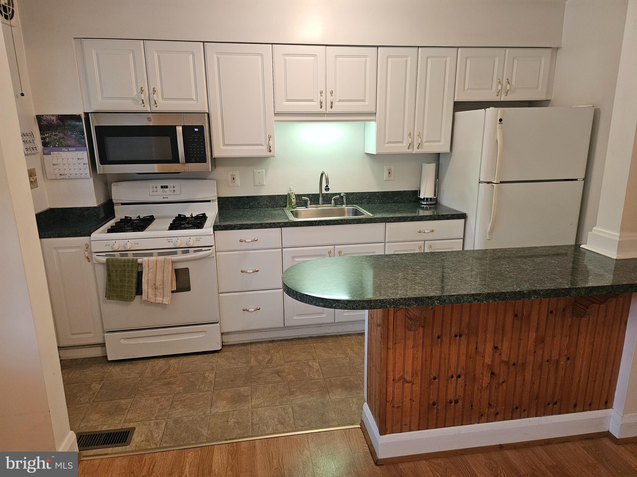 6907 Belclare Road Baltimore, MD 21222 - Photo 5 of 26 a kitchen with a sink a stove and refrigerator