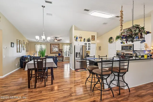 a kitchen with stainless steel appliances granite countertop a stove and a microwave