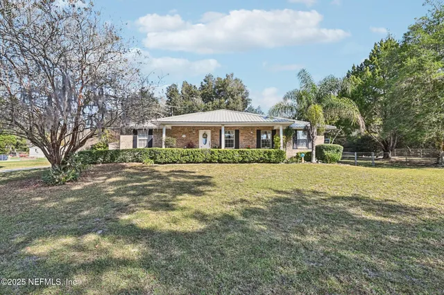a house that has a tree in front of it