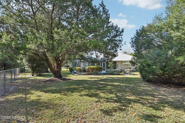 an aerial view of a house with yard swimming pool and outdoor seating