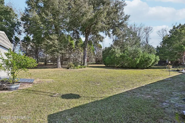 an aerial view of residential house with beach and outdoor space