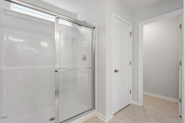 a bathroom with a glass shower door