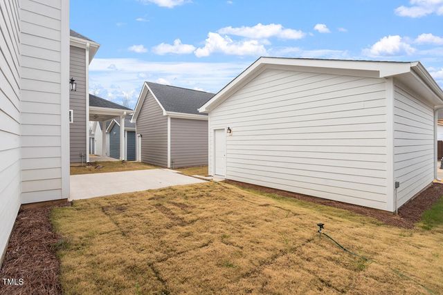 a view of a white house with a yard