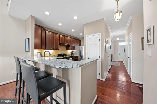 a large kitchen with a table and chairs
