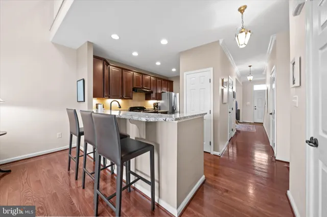 a kitchen with granite countertop wooden cabinets and a stove top oven