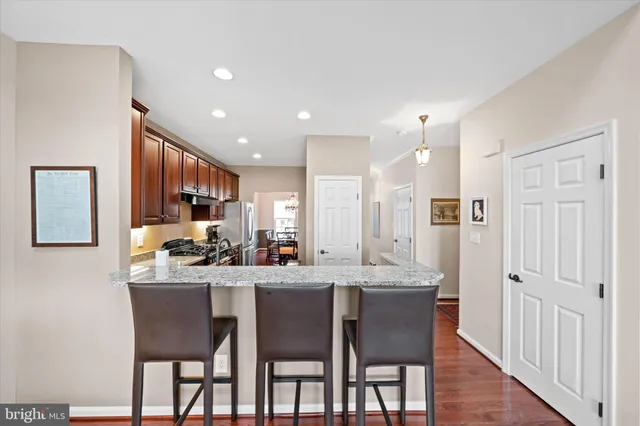 a kitchen with granite countertop a stove sink and cabinets