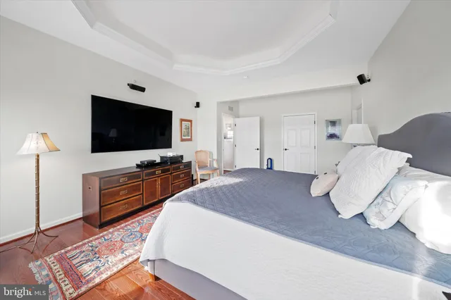 a spacious bathroom with a tub mirror and shower