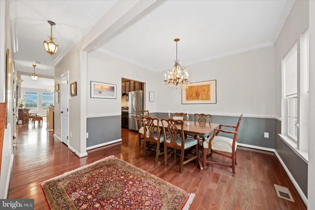 a dining room with furniture window wooden floor and chandelier