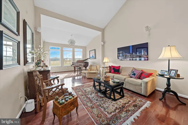 a living room with furniture and a dining table with kitchen view