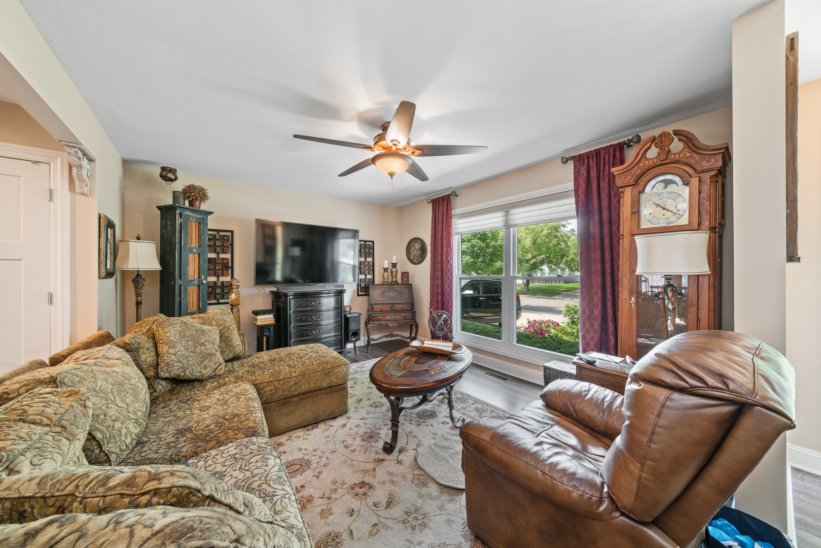 51 Winrock Road Montgomery, IL 60538 - Photo 3 of 26 a living room with furniture a flat screen tv and a large window
