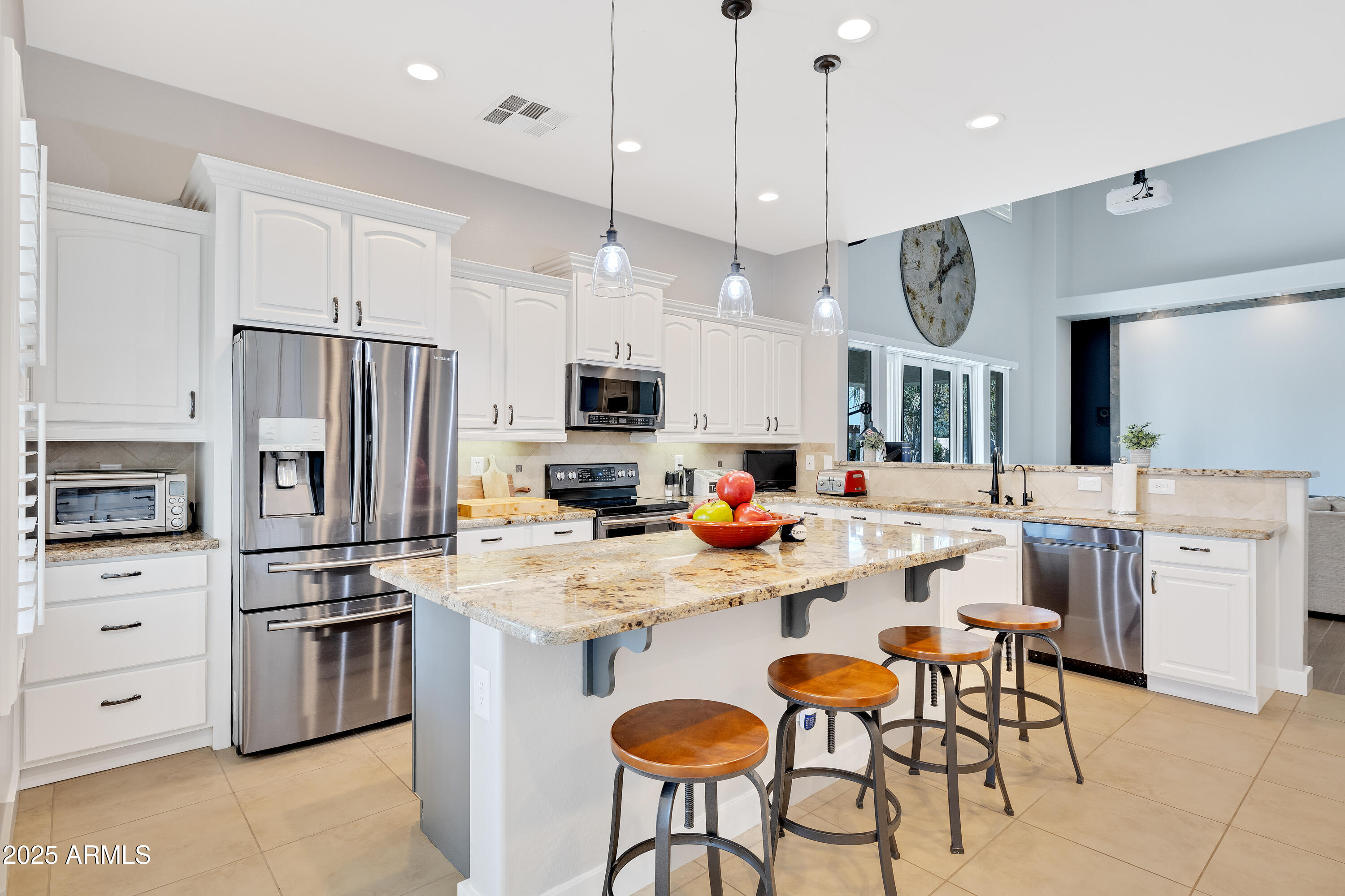 16896 North Palo Rojo Road Maricopa, AZ 85138 - Photo 11 of 48 a kitchen with white cabinets and stainless steel appliances