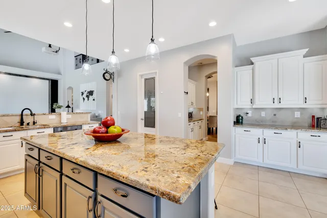 a kitchen with kitchen island a sink stainless steel appliances and cabinets