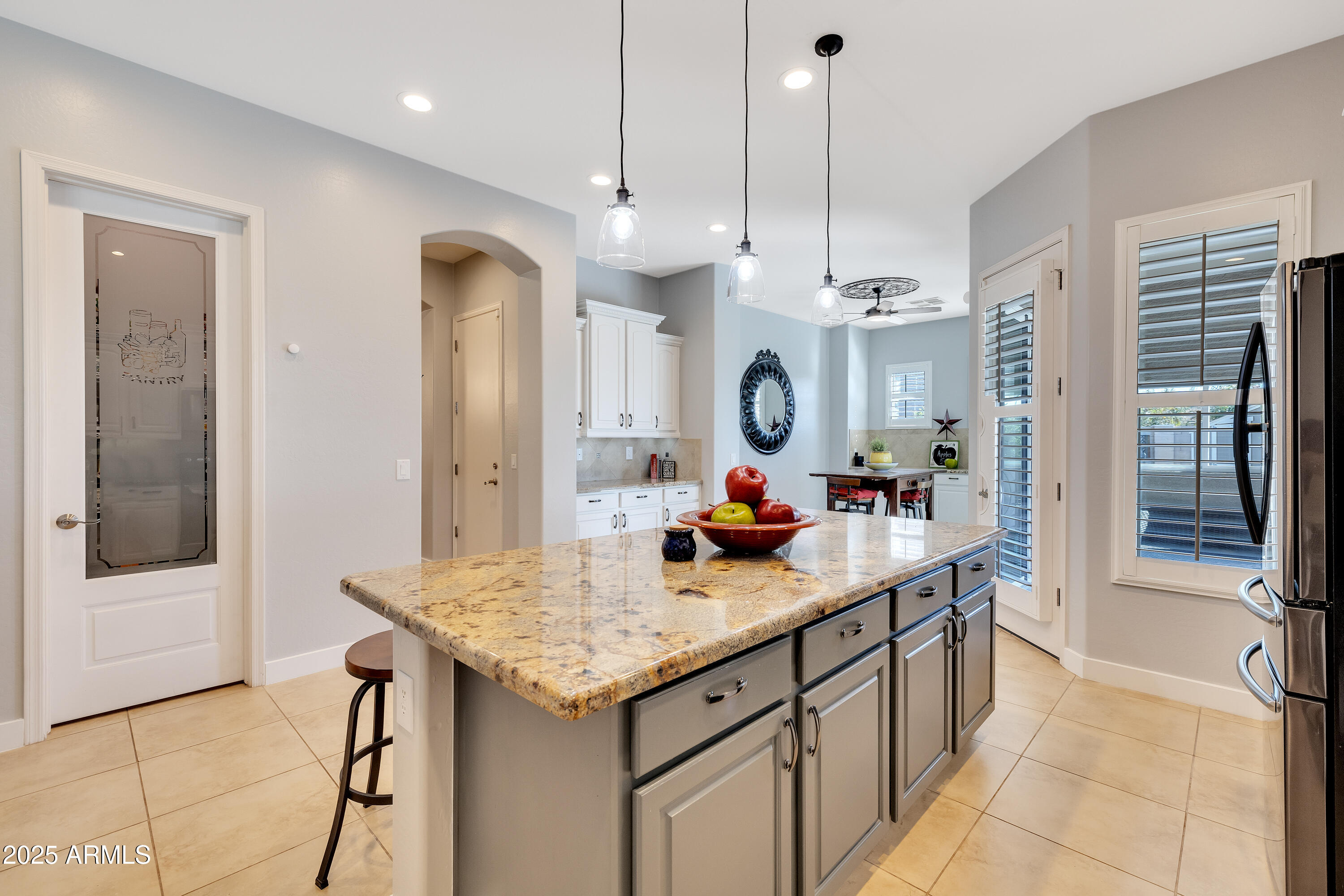 16896 North Palo Rojo Road Maricopa, AZ 85138 - Photo 14 of 48 a kitchen with stainless steel appliances granite countertop a sink a oven a dining table and chairs