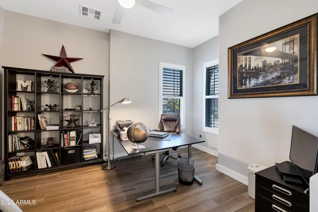 a view of a workspace with furniture and wooden floor