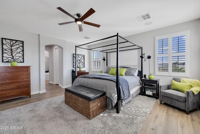 a spacious bedroom with a bed a couch and a window