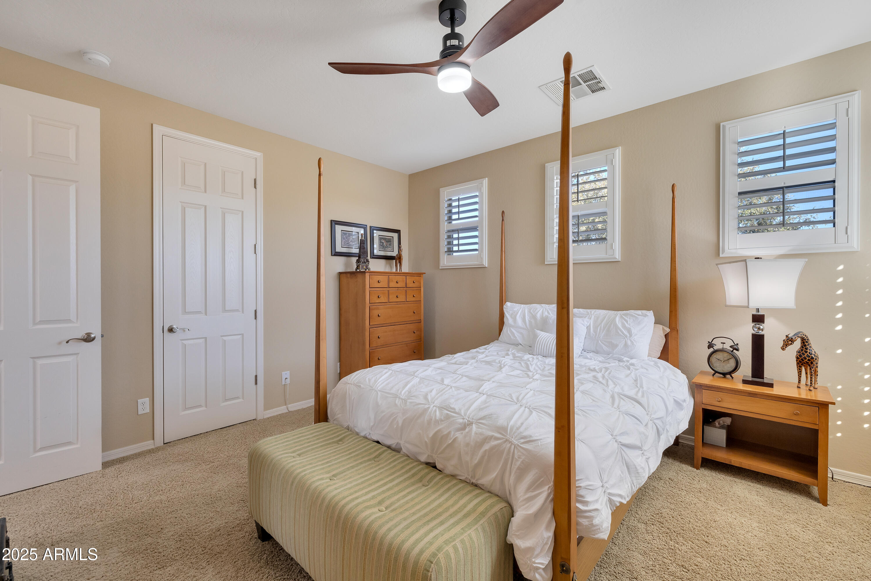 16896 North Palo Rojo Road Maricopa, AZ 85138 - Photo 24 of 48 a bedroom with a bed and a chandelier