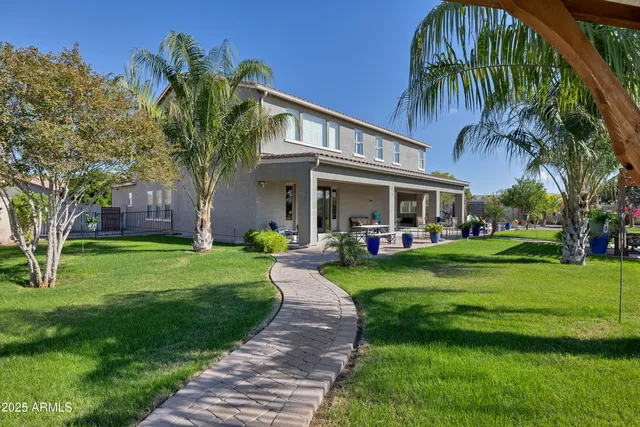 a patio with a table and chairs and a yard